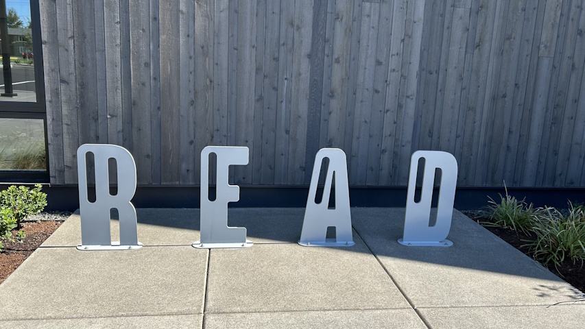 Read spelled out in individual letters mounted in the sidewalk before the new building