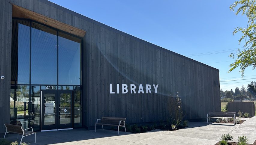 View of the LIBRARY sign on the front wall of the Woodland library