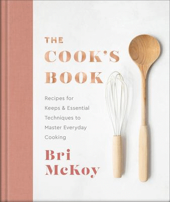 Pale background with whisk and wooden spoon and the words the cook's book